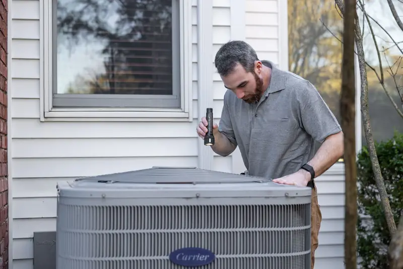 Technician servicing an outdoor air conditioning unit